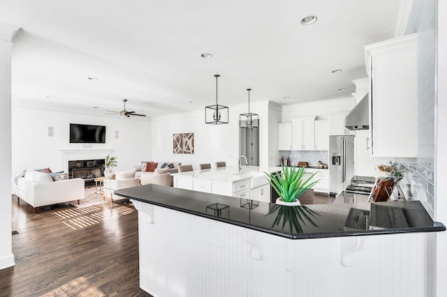 kitchen with backsplash, stainless steel appliances, dark wood-type flooring, decorative light fixtures, and white cabinets