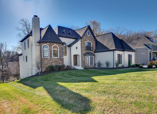 french country inspired facade with a front yard