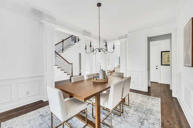 dining space featuring dark hardwood / wood-style flooring, a chandelier, and ornamental molding