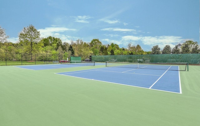 view of tennis court with basketball hoop