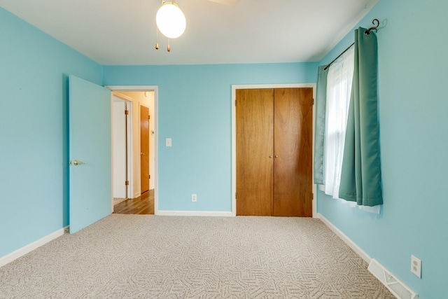 unfurnished bedroom with carpet and a closet