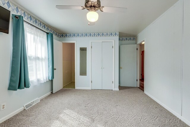 unfurnished bedroom featuring ceiling fan and light colored carpet