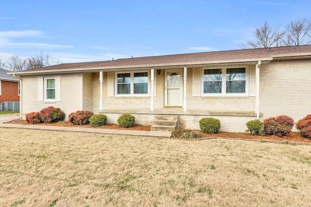 ranch-style home featuring central AC and a front lawn