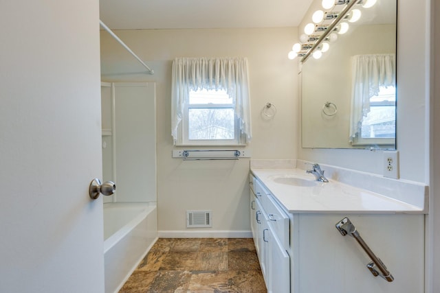 bathroom featuring vanity and shower / tub combination