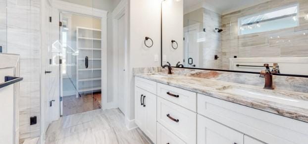 bathroom featuring vanity and an enclosed shower