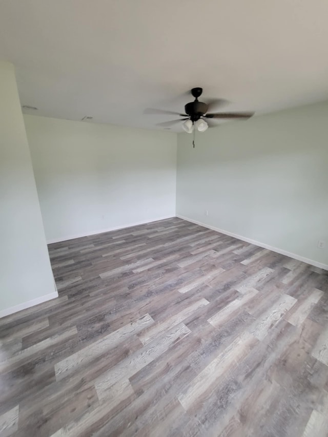 spare room with light wood-type flooring and ceiling fan