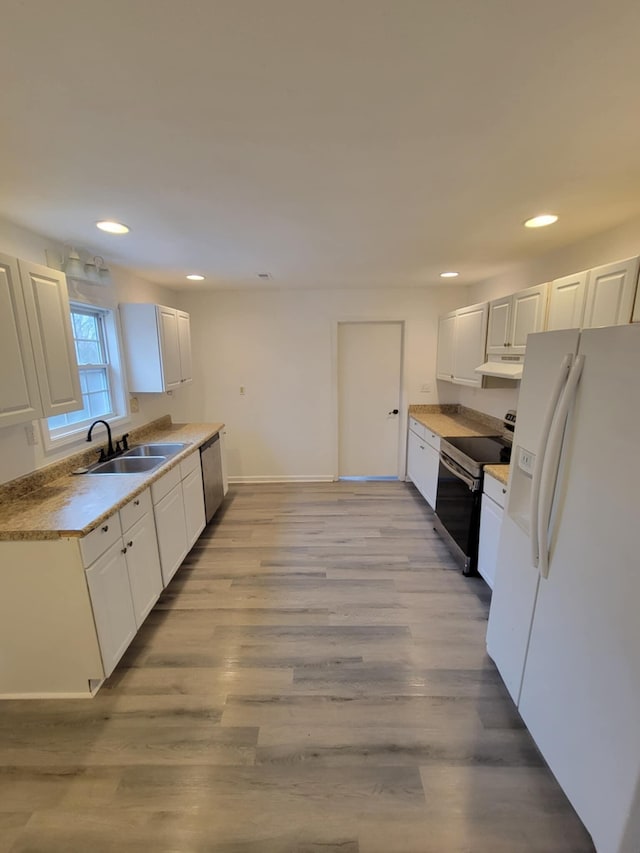 kitchen featuring light hardwood / wood-style floors, white cabinetry, and appliances with stainless steel finishes