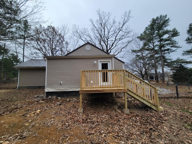 rear view of house featuring a wooden deck