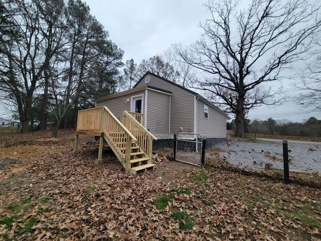 rear view of property featuring a deck