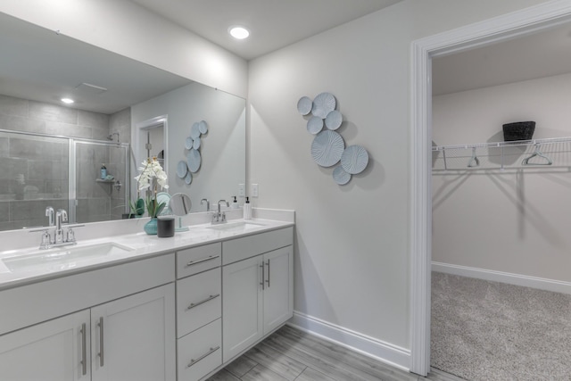 bathroom featuring hardwood / wood-style floors, vanity, and an enclosed shower