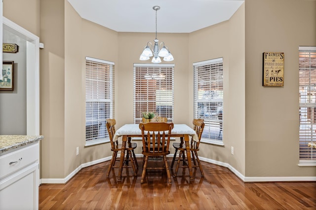 dining space featuring an inviting chandelier and light hardwood / wood-style flooring