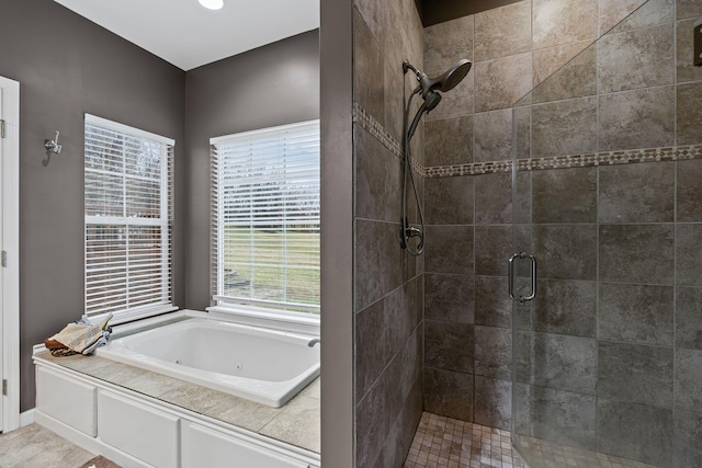 bathroom featuring plenty of natural light and plus walk in shower