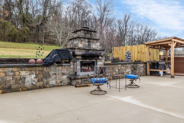 view of patio / terrace with an outdoor stone fireplace