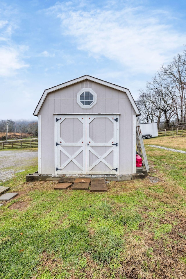 view of outbuilding with a yard and a rural view