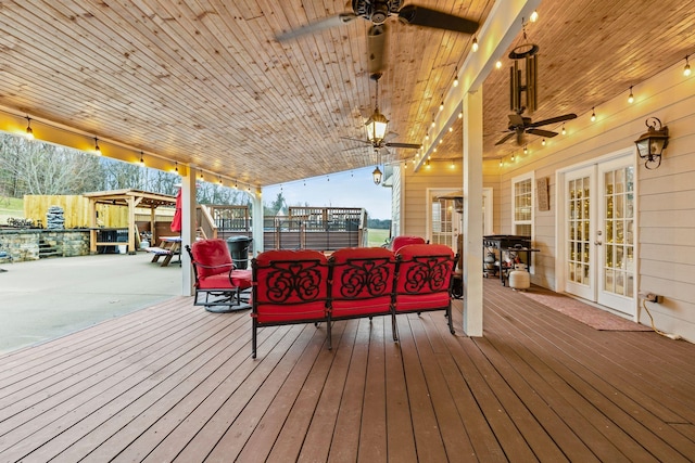 deck with ceiling fan, an outdoor hangout area, and french doors