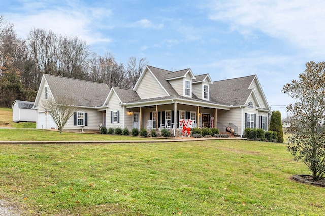 view of front of home with covered porch, a garage, and a front lawn