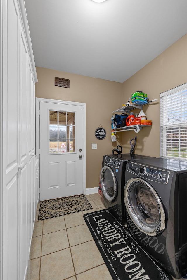 laundry room with light tile patterned floors and separate washer and dryer