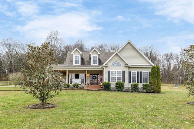 new england style home featuring a porch and a front lawn