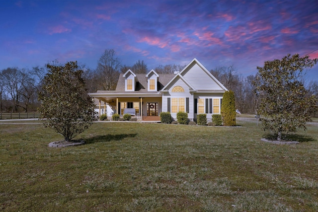 view of front of home with covered porch and a front lawn