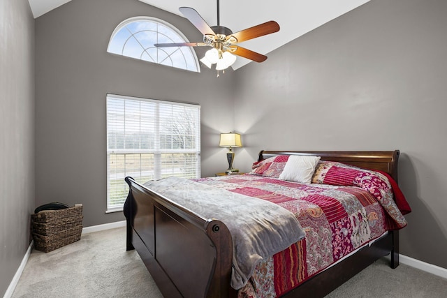 carpeted bedroom featuring high vaulted ceiling, multiple windows, and baseboards