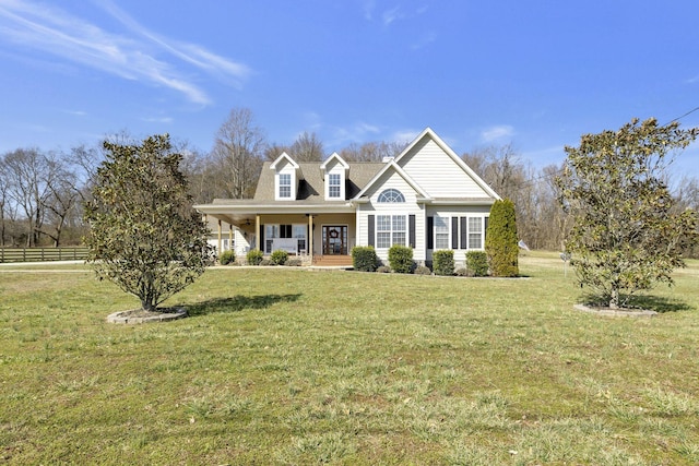 view of front of house with a front lawn, a porch, and fence