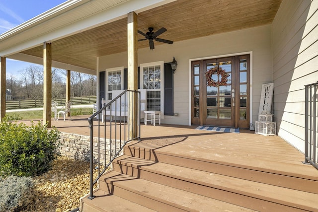 entrance to property with ceiling fan and a porch