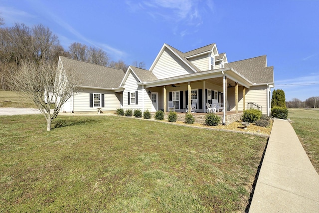 view of front of home with a porch, a front yard, ceiling fan, and a shingled roof