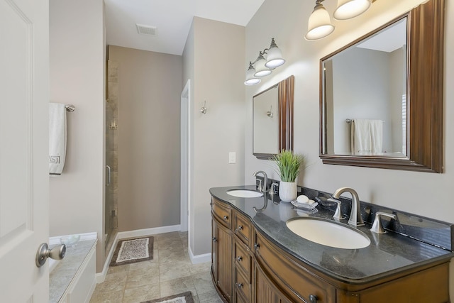 bathroom featuring double vanity, a stall shower, a sink, and visible vents