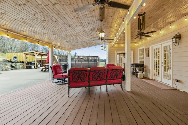 deck with a ceiling fan and french doors