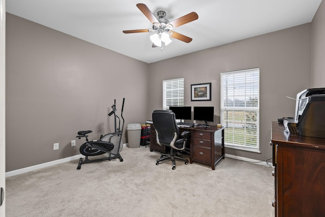 home office featuring ceiling fan, baseboards, and light colored carpet