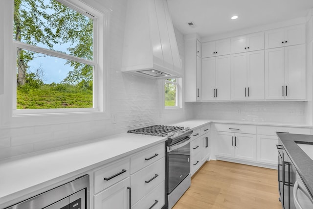 521 Matthew Miller Dr, Smyrna, TN 37167 - kitchen featuring stainless steel gas range, custom range hood, backsplash, light countertops, and recessed lighting