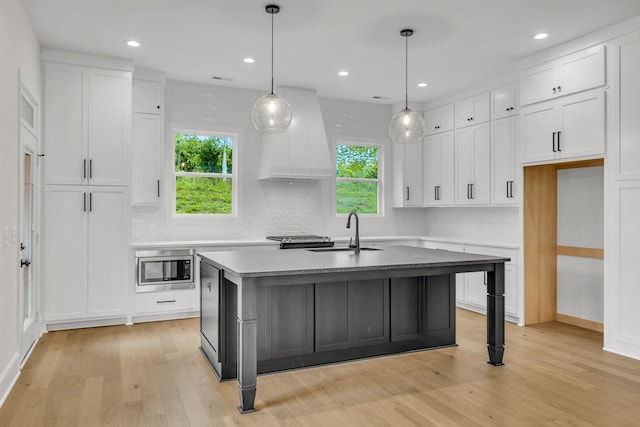 521 Matthew Miller Dr, Smyrna, TN 37167 - kitchen with tasteful backsplash, plenty of natural light, premium range hood, stainless steel microwave, and recessed lighting