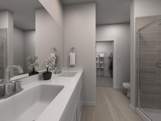 bathroom featuring walk in shower, toilet, vanity, and hardwood / wood-style flooring