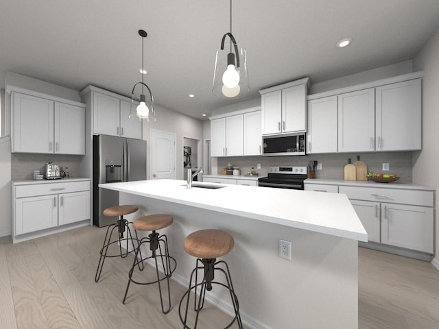 kitchen with hanging light fixtures, sink, stainless steel appliances, and a center island with sink