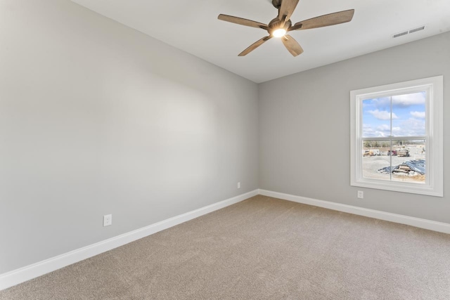 spare room featuring ceiling fan and carpet