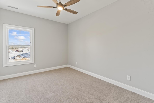 carpeted spare room featuring ceiling fan