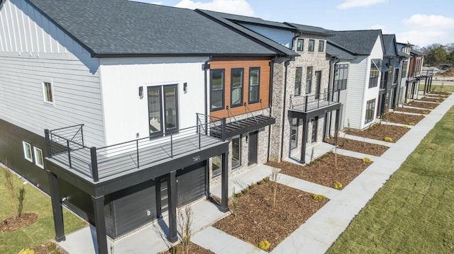 exterior space featuring a yard and a balcony