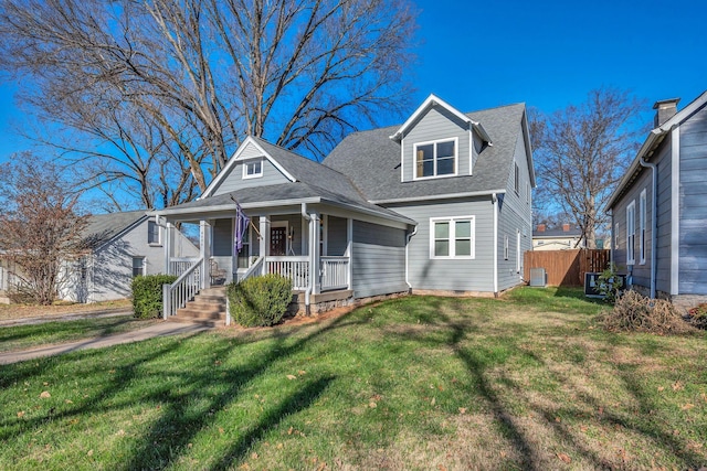 view of front of home with central AC unit, a porch, and a front lawn