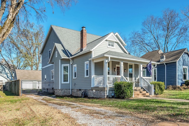 bungalow-style house featuring covered porch and a front yard