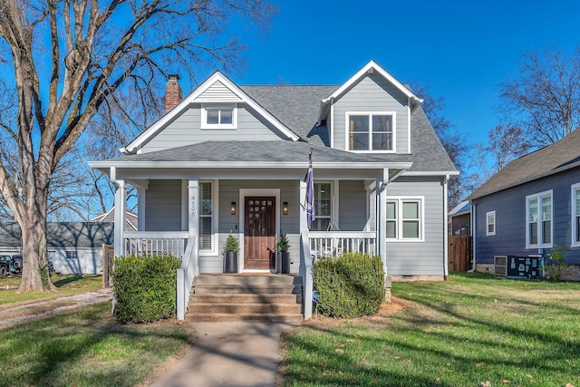 bungalow featuring a front yard and covered porch