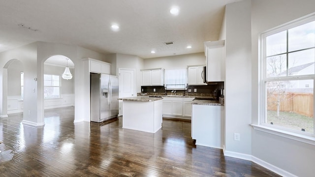 kitchen featuring white cabinetry, a center island, dark hardwood / wood-style floors, and stainless steel refrigerator with ice dispenser