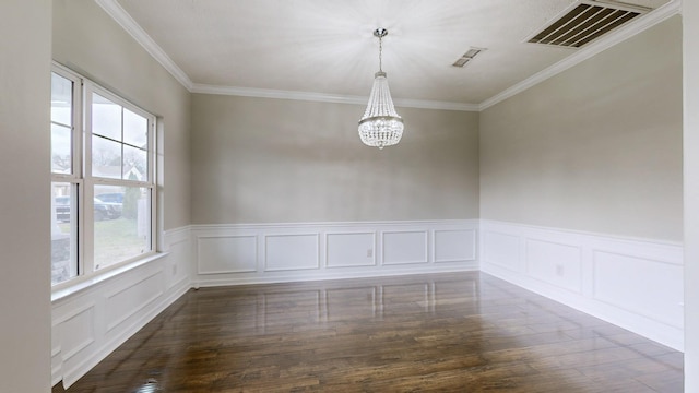 empty room with a chandelier, dark wood-type flooring, and a healthy amount of sunlight