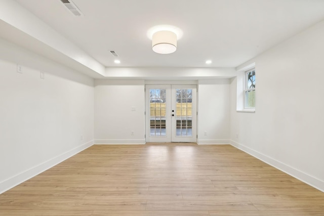 unfurnished room with french doors and light hardwood / wood-style floors