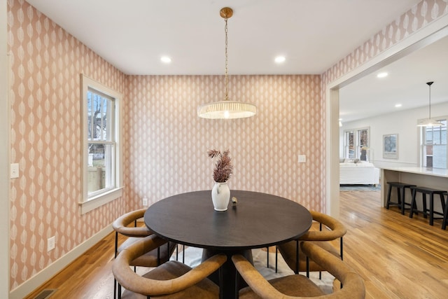 dining space with plenty of natural light and light wood-type flooring