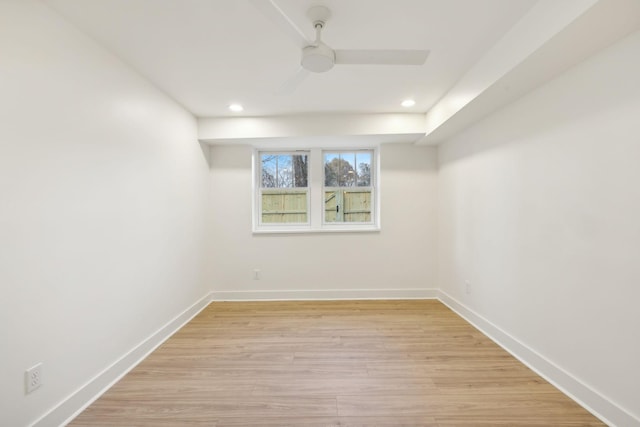 basement with ceiling fan and light wood-type flooring