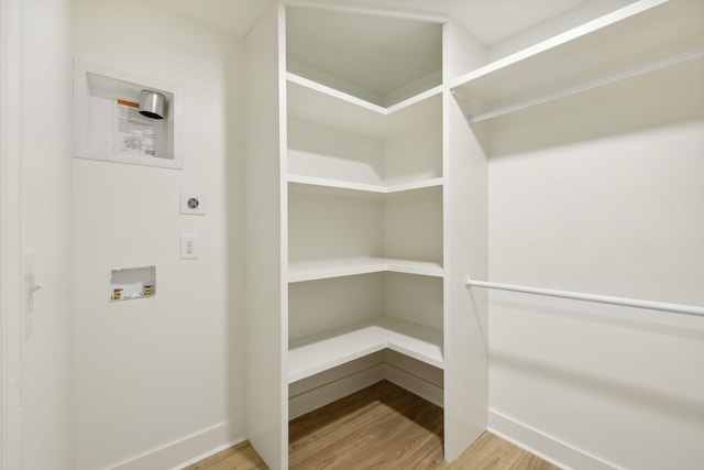 spacious closet with hardwood / wood-style flooring