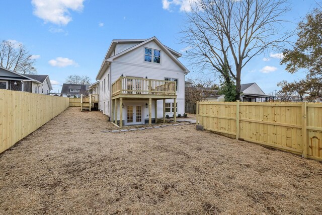 rear view of property with a wooden deck and french doors