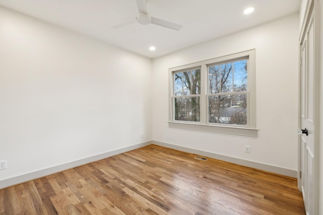 empty room with hardwood / wood-style flooring and ceiling fan