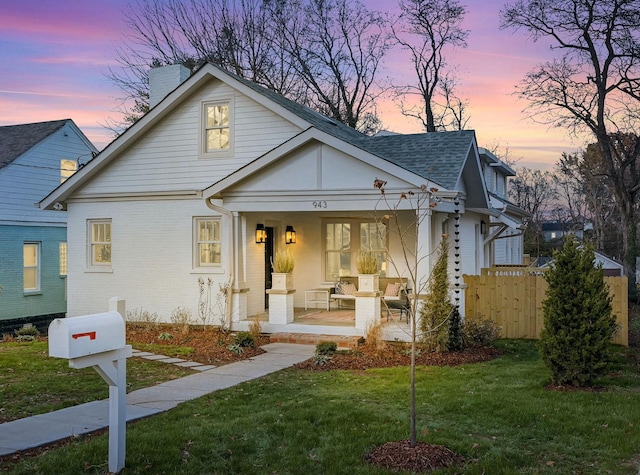 view of front of home with a yard and covered porch