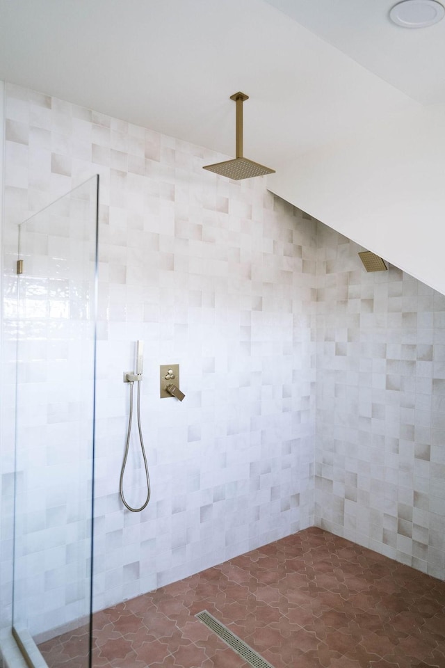 laundry area with tile walls